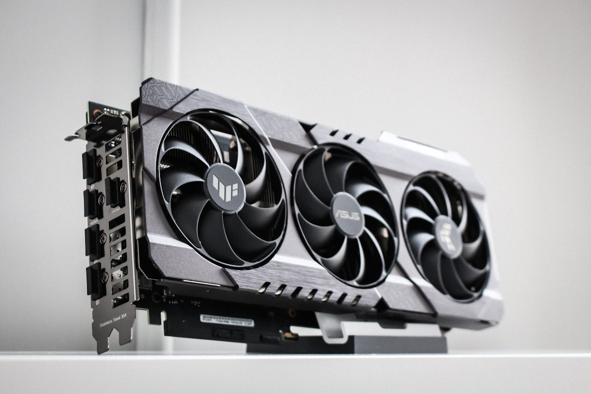 A high-end graphics card with triple cooling fans on a white shelf