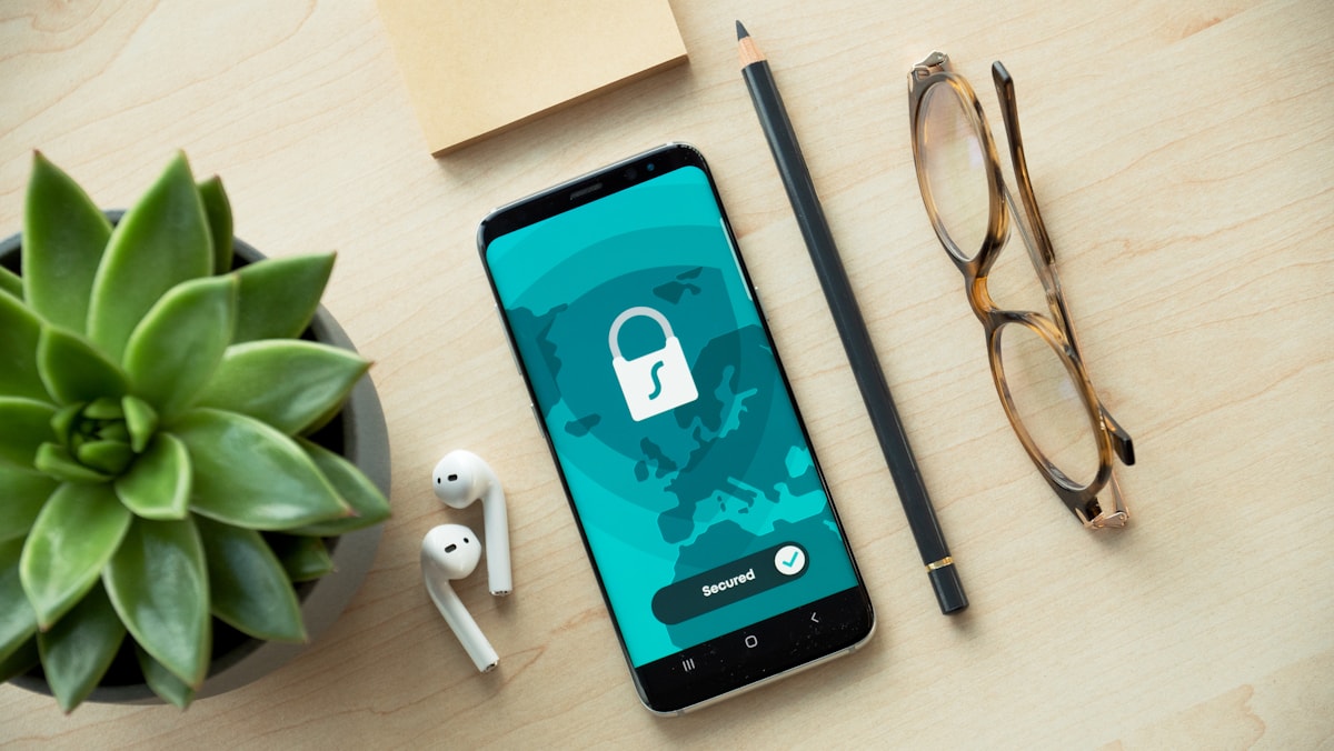 A phone on a desk displaying a padlock icon and the word Secured